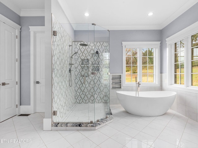 bathroom with tile walls, ornamental molding, separate shower and tub, and tile patterned floors