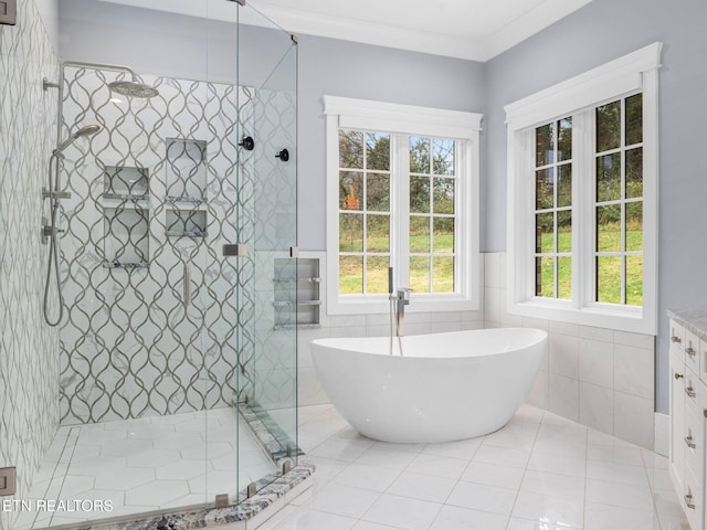 bathroom featuring tile walls, shower with separate bathtub, crown molding, and vanity