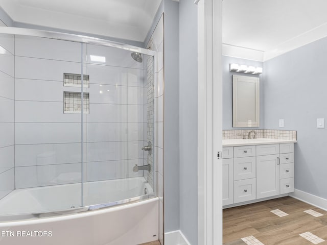 bathroom with enclosed tub / shower combo, vanity, decorative backsplash, and wood-type flooring