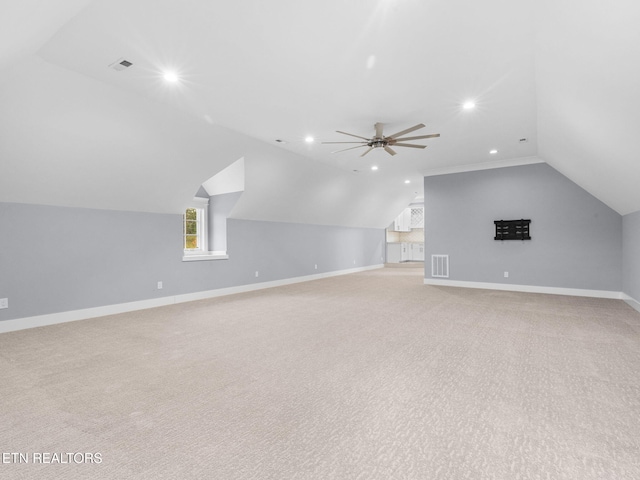 bonus room with light carpet, ceiling fan, and vaulted ceiling