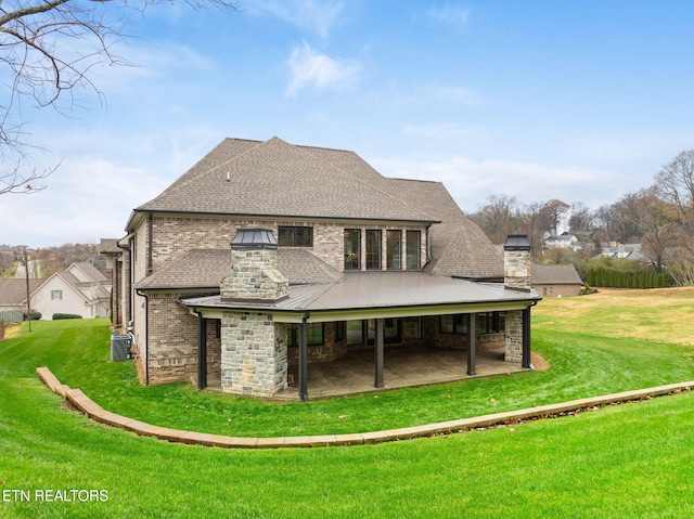 rear view of property with a yard and a patio