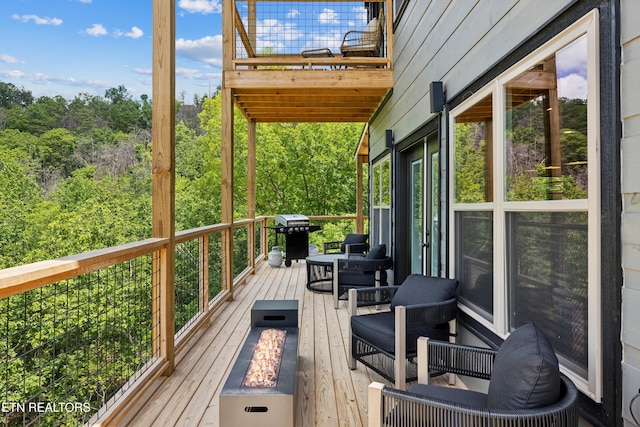 deck with a fire pit and grilling area