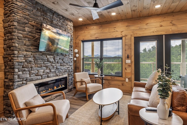 living room featuring ceiling fan, wood ceiling, french doors, and wood walls