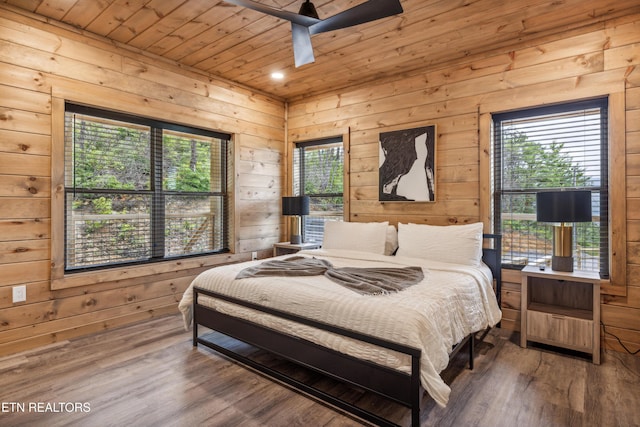 bedroom with wood walls, ceiling fan, hardwood / wood-style flooring, and wood ceiling