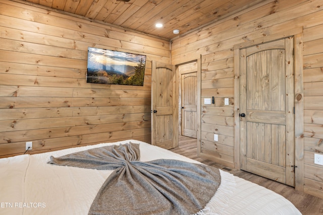 bedroom with wood walls, light wood-type flooring, and wood ceiling