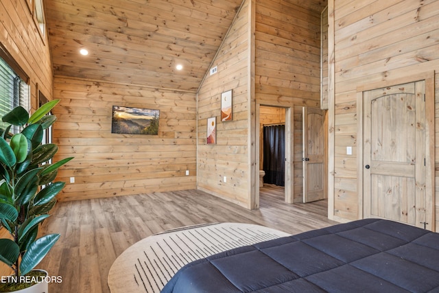 unfurnished bedroom with high vaulted ceiling, wood walls, light hardwood / wood-style flooring, and wooden ceiling