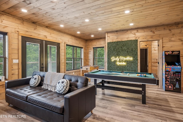 playroom featuring french doors, wooden walls, billiards, and light hardwood / wood-style flooring