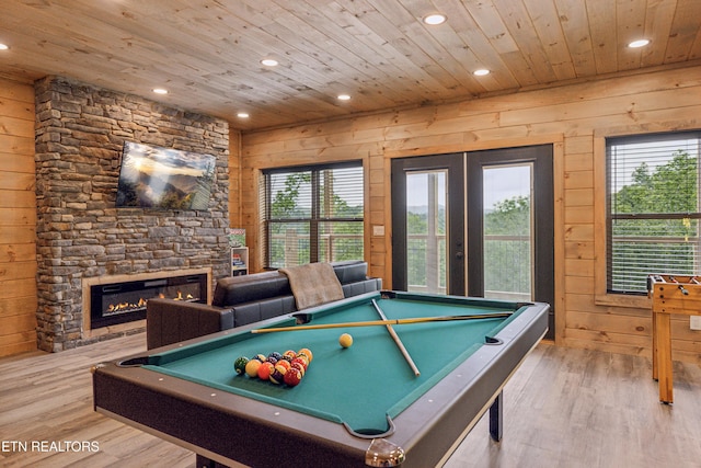 playroom featuring a fireplace, billiards, light wood-type flooring, wood walls, and wood ceiling