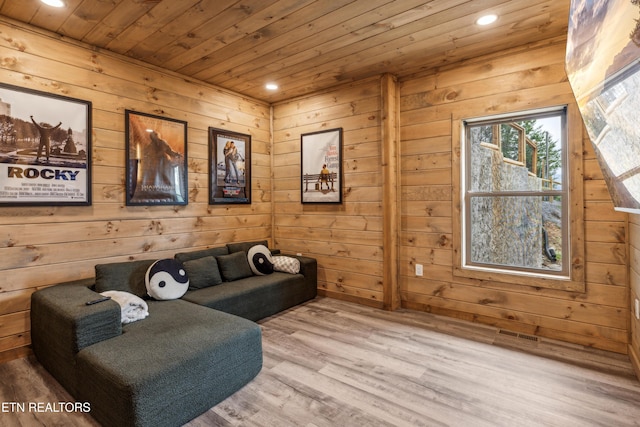 sitting room with wood ceiling, light hardwood / wood-style flooring, and wooden walls