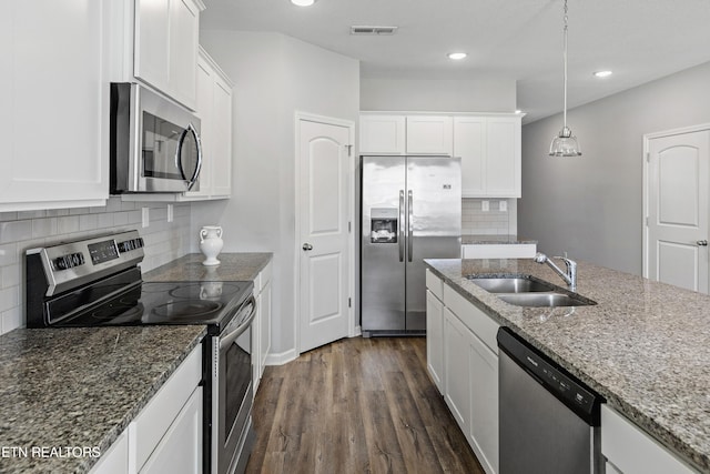 kitchen featuring white cabinets, appliances with stainless steel finishes, sink, and stone countertops