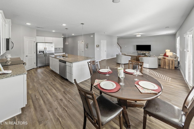 dining area featuring sink and hardwood / wood-style floors