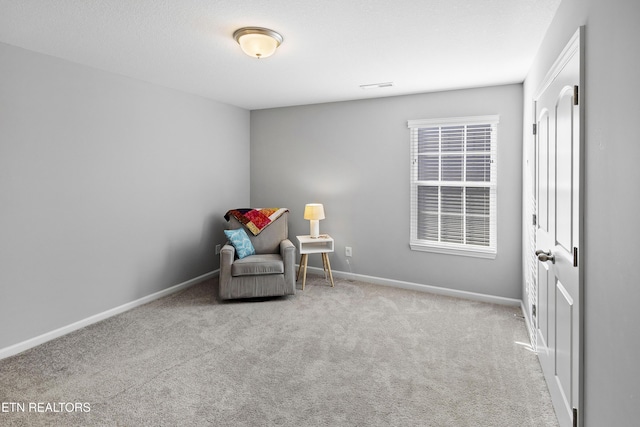 living area featuring light colored carpet