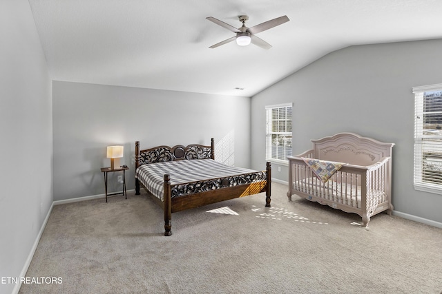 bedroom with ceiling fan, carpet flooring, and lofted ceiling