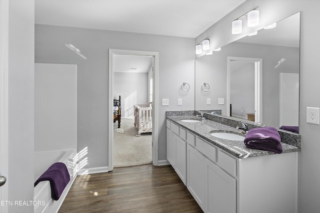 bathroom featuring hardwood / wood-style flooring, shower / bathing tub combination, and vanity