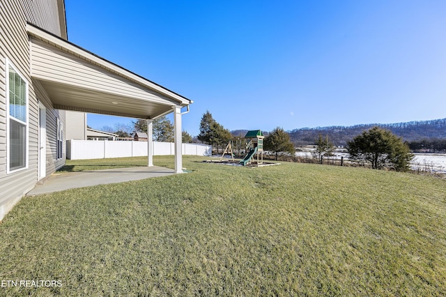 view of yard with a playground and a patio