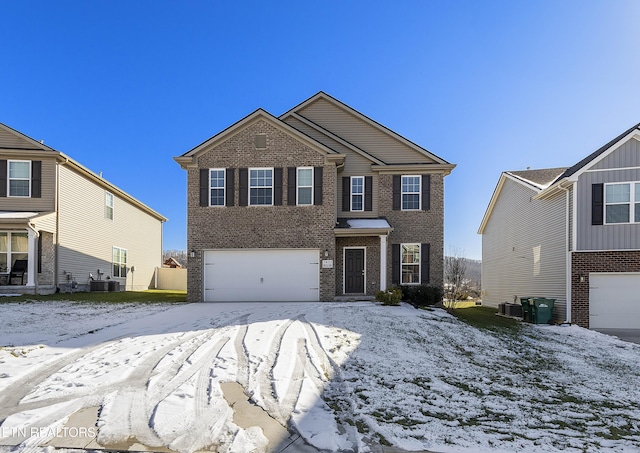 view of front of home featuring central AC unit and a garage