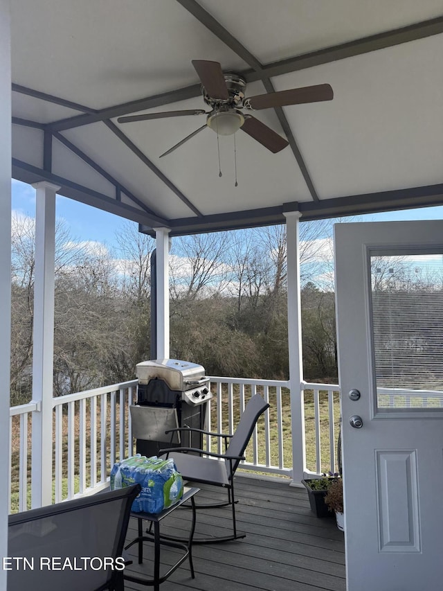 wooden deck with ceiling fan and a grill