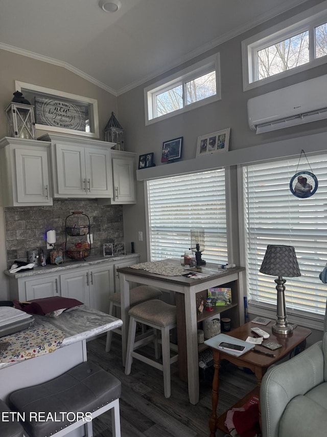 kitchen featuring white cabinetry, dark hardwood / wood-style flooring, backsplash, a wall mounted AC, and vaulted ceiling