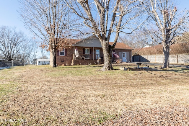 exterior space featuring covered porch and a front lawn