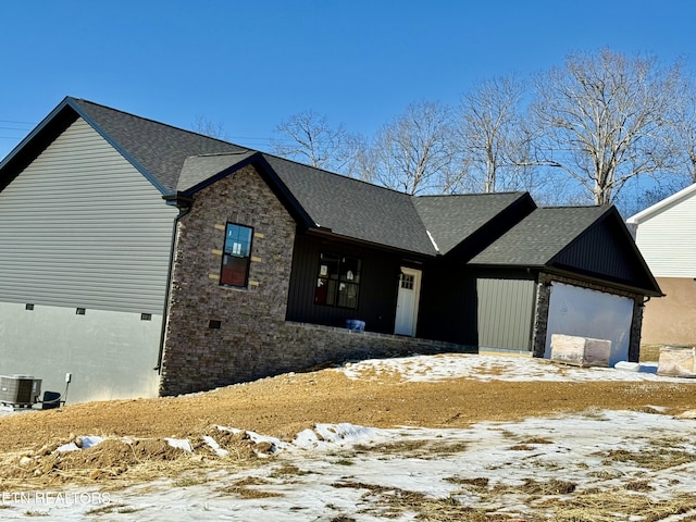 view of front of house featuring a garage and central air condition unit