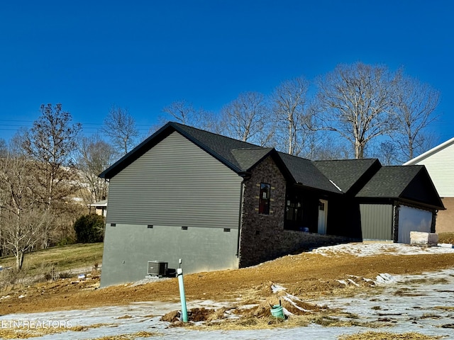 view of snowy exterior with a garage