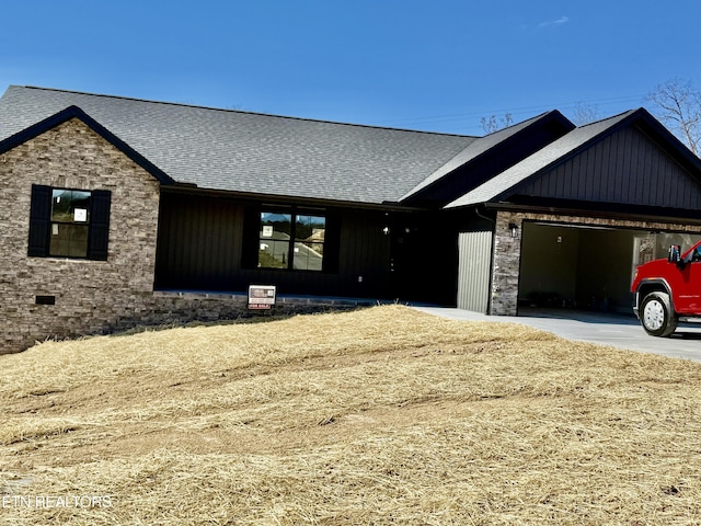 view of front facade featuring a garage, concrete driveway, roof with shingles, and board and batten siding