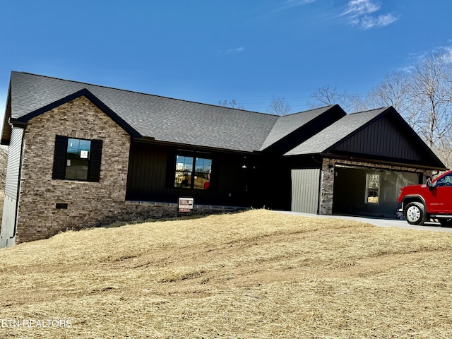 view of front of house featuring an attached garage, stone siding, a shingled roof, and concrete driveway