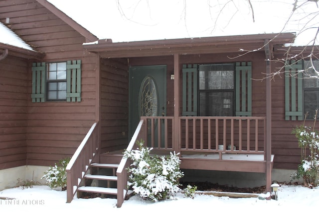 view of snow covered property entrance