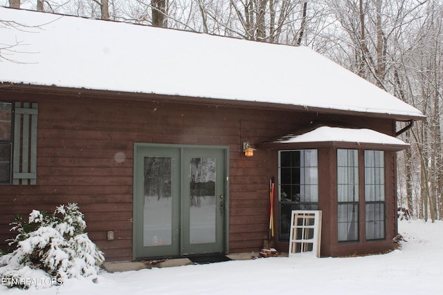 view of snow covered property entrance