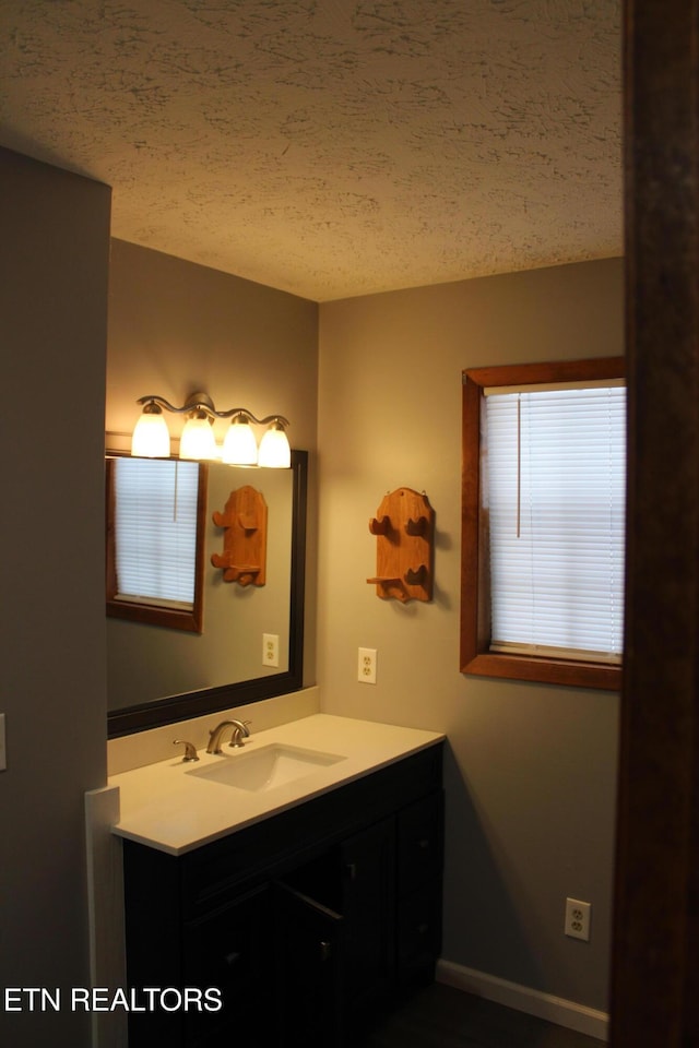 bathroom with a textured ceiling and vanity