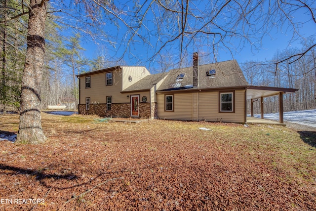 back of house with a carport