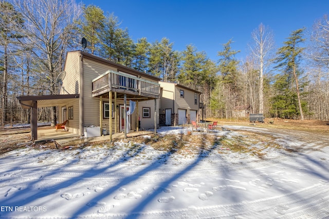 view of front of house with a deck and a garage