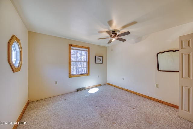 unfurnished room featuring ceiling fan and light colored carpet