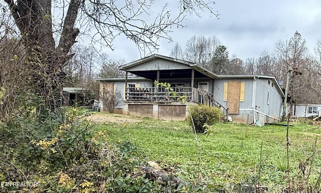 back of property featuring a lawn