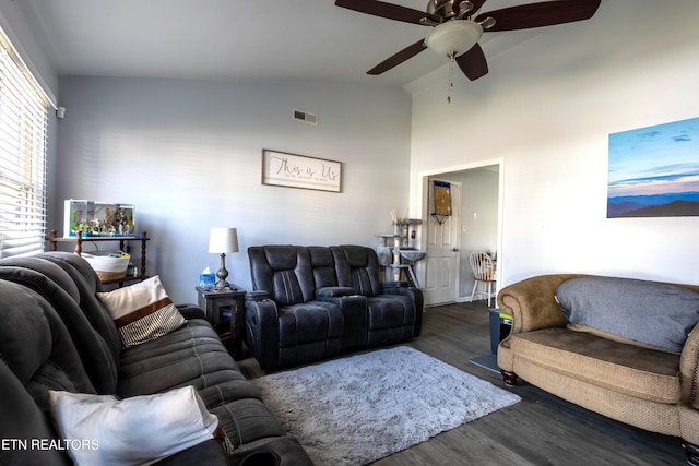 living room featuring ceiling fan, dark hardwood / wood-style floors, and vaulted ceiling