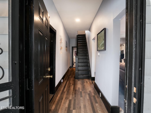 hallway with dark hardwood / wood-style flooring