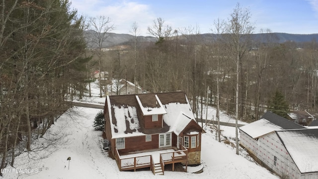 snowy aerial view featuring a mountain view