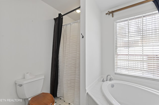 bathroom featuring toilet and independent shower and bath