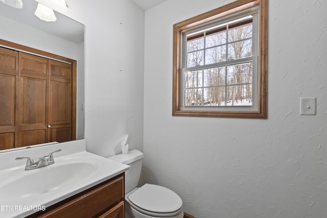 bathroom featuring toilet and vanity