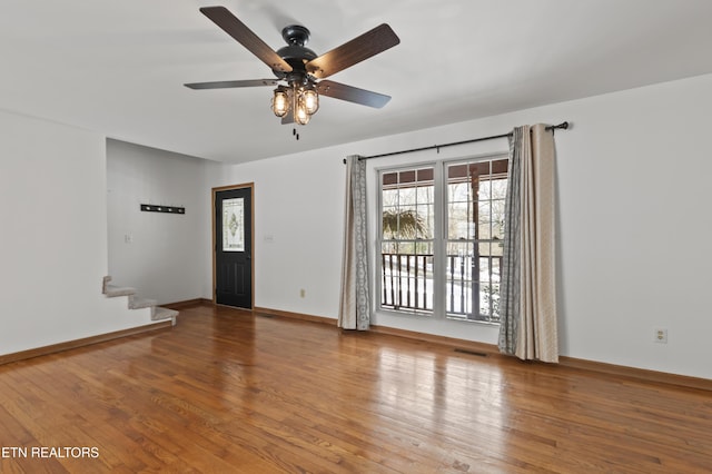 empty room with wood-type flooring and ceiling fan