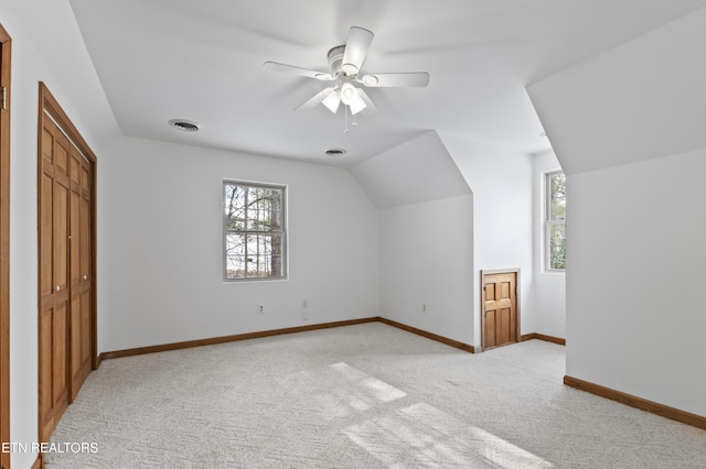 bonus room with ceiling fan, light carpet, and lofted ceiling