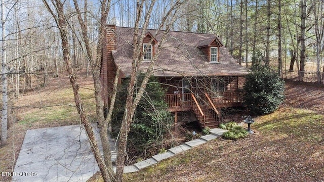 view of home's exterior with stairs and a chimney