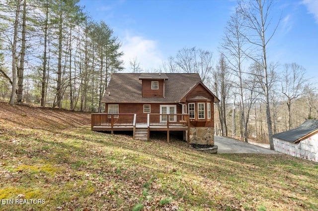 rear view of house featuring a wooden deck