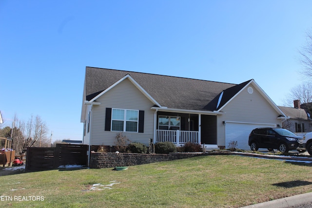 ranch-style home featuring covered porch, a front yard, and a garage