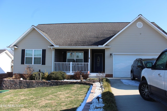 ranch-style home featuring a porch, a front yard, and a garage