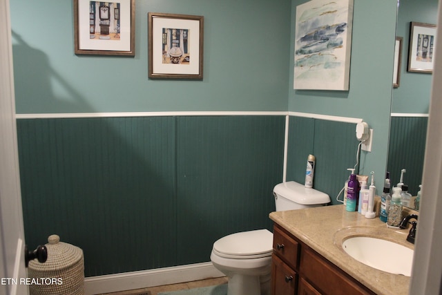 bathroom featuring toilet, tile patterned floors, and vanity