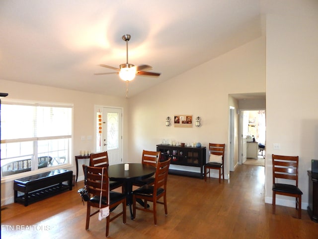 dining space featuring lofted ceiling, ceiling fan, and dark wood-type flooring