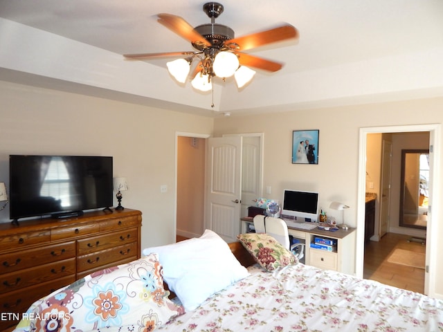 bedroom featuring ceiling fan and ensuite bath