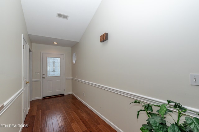 doorway to outside with vaulted ceiling and dark hardwood / wood-style floors