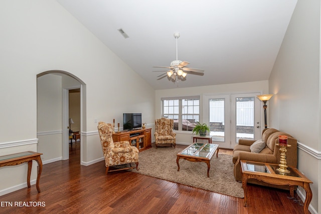 living room with ceiling fan, vaulted ceiling, and dark hardwood / wood-style flooring